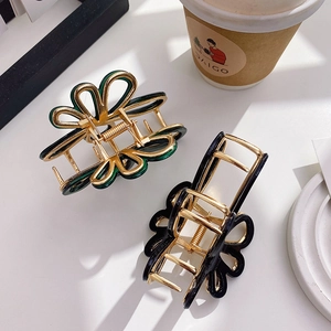 Floral acetate hair claw clips in dark green and black with elegant gold metal frame