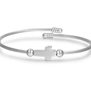 Detail of vintage silver cross bracelet with twisted steel wire texture and open cuff design