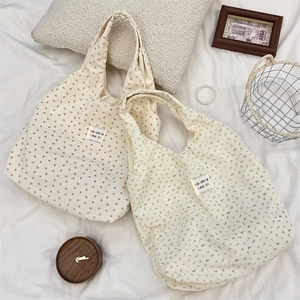 Détail de la texture des sacs cabas en velours côtelé fleuri avec étiquettes vintage