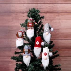 Set of six knitted Christmas gnomes with antlers and snowflakes on a festive pine tree