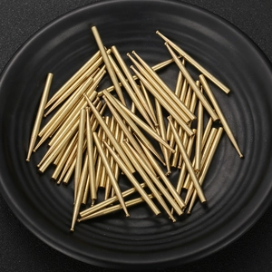 Bulk gold-plated ball head pins and T-pins for jewelry making on a black tray