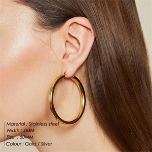 Close-up of a 4mm wide and 50mm diameter polished gold stainless steel hoop earring