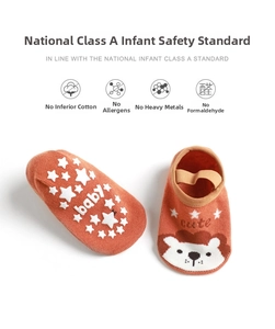 Detail of baby non-slip floor socks with silicone star grips and cute lion embroidery