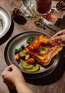 Gourmet toast with fresh fruit served on a vintage industrial gold stainless steel plate