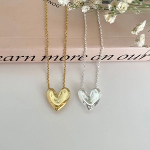 Artistic matte heart necklaces in gold and silver finish with molten lava texture