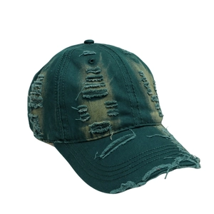 Close-up of vintage dark green washed cotton baseball cap with distressed torn details