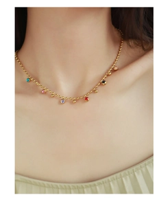 Detail of colorful drip oil bean pendants on a gold plated 18k titanium steel necklace
