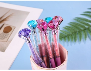 Colorful diamond top crystal pens with glitter sand in a stylish pink marble holder