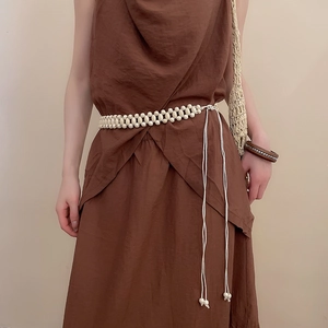 Detailed view of handmade cream resin bead waist chain on a cotton dress