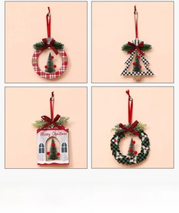 Close-up of four wooden Christmas ornaments with pine needles and festive bows
