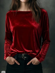 Detailed view of red velvet texture on long-sleeve crewneck top with premium glossy finish