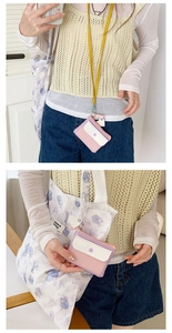 Detail of macaron-colored PU leather coin purse with yellow lanyard and snap button