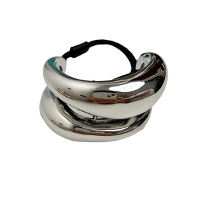 Minimalist double-layered silver metal hair tie for high-end bun styling on white background
