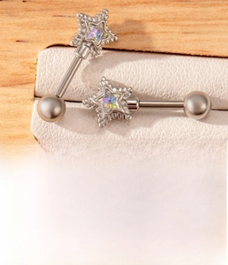 Detailed view of silver star ear stud made of titanium steel with rainbow zircon inlay