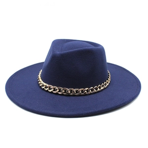 Close-up of navy blue wool fedora hat featuring a chunky gold metal chain detail