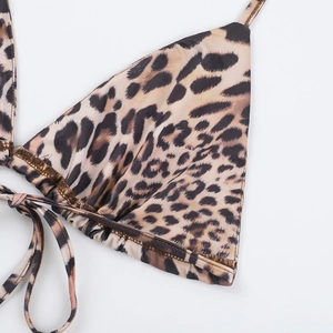 Close-up of leopard print bikini top showing ruched edge detail and drawstring tie