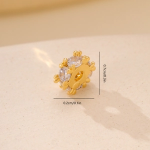 Macro view of a 7mm gold metal spacer bead with cubic zirconia and dimension guides