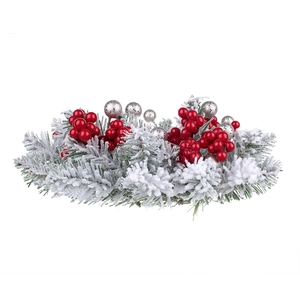Close-up of frosted pine needles with red berries and silver balls for candle ring