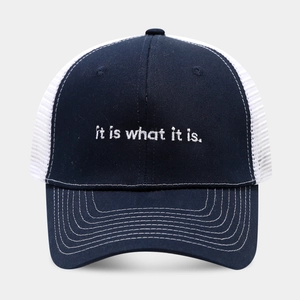 Detail of navy trucker hat featuring white breathable mesh and slogan embroidery
