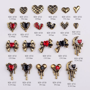 Vintage gold alloy nail art charms with heart and bow designs in a set of 22 styles