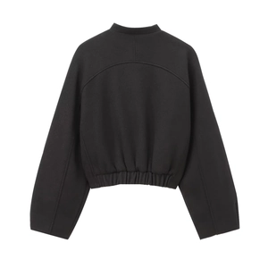 Back view of a black cropped bomber jacket featuring elastic waist and knit fabric
