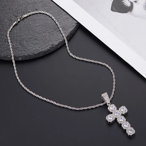 Macro shot of silver twisted rope chain and cross pendant with inlaid cubic zirconia