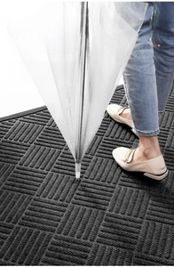 Detail of dark grey doormat showing ribbed anti-slip texture and water absorption function