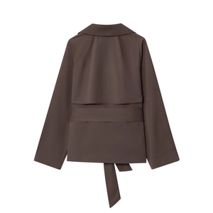 Detail view of deep coffee short trench coat back design with waist belt and cape overlay