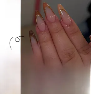 French brown almond press-on nails with gold glitter details and model display