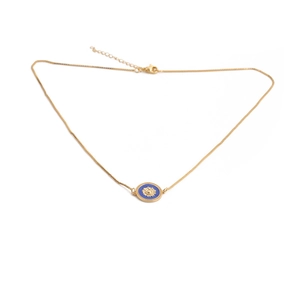 Close-up of golden necklace with blue sun pendant and beaded edge detail on white background