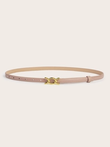 Detail view of a slim apricot leather belt with interlocking gold buckle on beige background