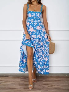 Detail of blue floral maxi dress featuring scalloped edges and pink flower patterns