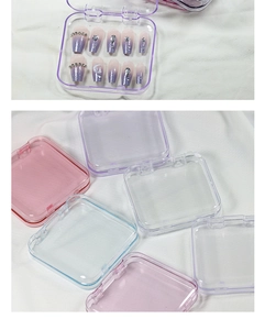 Detailed view of colorful transparent press-on nail display boxes on a soft cloth