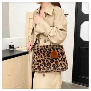 Leopard print plush shoulder bag with gold chain strap and fluffy pompom detail