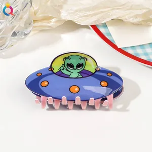 Detailed macro view of an acrylic UFO spaceship hair claw clip in a lifestyle setting