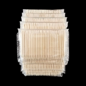 Bulk packs of double-ended orange wood nail sticks with pointed tips in clear bags