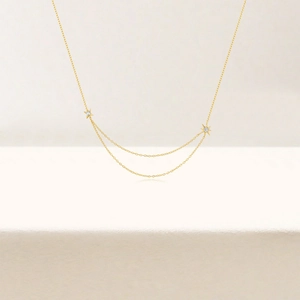 Close-up of elegant double-layered gold star necklace with shimmering diamond accents