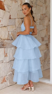 Detail of light blue tiered ruffle dress with backless halter straps and layered skirt