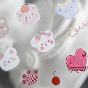Cute bear nail art stickers with macaron colored heart and cherry patterns on sheet