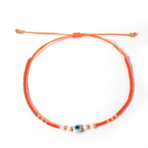 Bohemian orange beaded evil eye bracelet with adjustable cord and gold metal accents