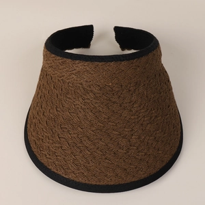 Detailed top view of a brown woven straw sun visor with black ribbon edge trim