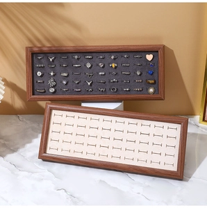 Detail of walnut wood jewelry tray with velvet lining for rings and earrings display