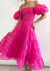 Detail of flamingo pink off-the-shoulder dress featuring tiered skirt and bubble sleeves