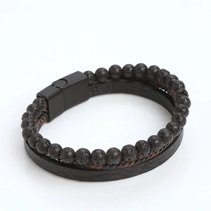 Detail of multi-layer men's bracelet with lava stone beads and woven leather magnetic clasp