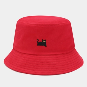 Close-up of red cotton bucket hat with cute black cat embroidery and stitched brim detail