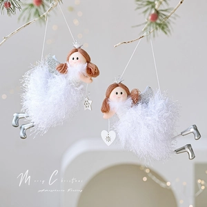 Plush Christmas angel ornaments with silver wings and wooden heart pendants hanging on a tree