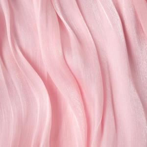 Close-up of pink chiffon dress fabric with elegant vertical pleats and pearly texture