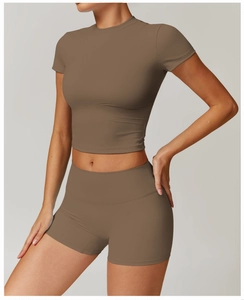 Close-up of seamless dark coffee yoga set featuring short sleeve crop top and high waist shorts