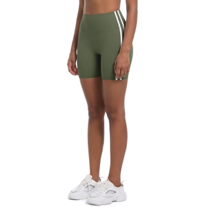 Detail view of olive green high-waisted yoga shorts with sporty double white side stripes