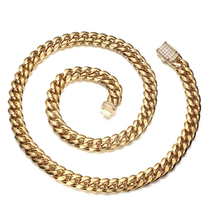 Detailed macro view of gold plated Cuban link chain necklace with iced out diamond buckle